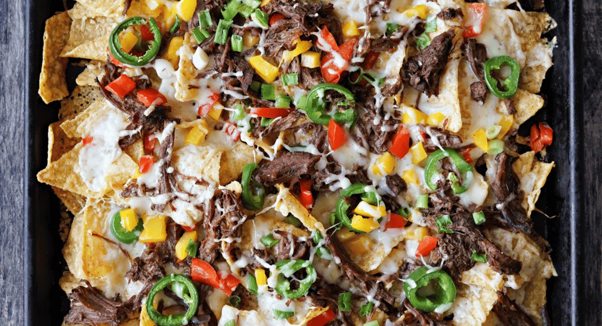 Overhead image of sheet pan nachoes with brisket.