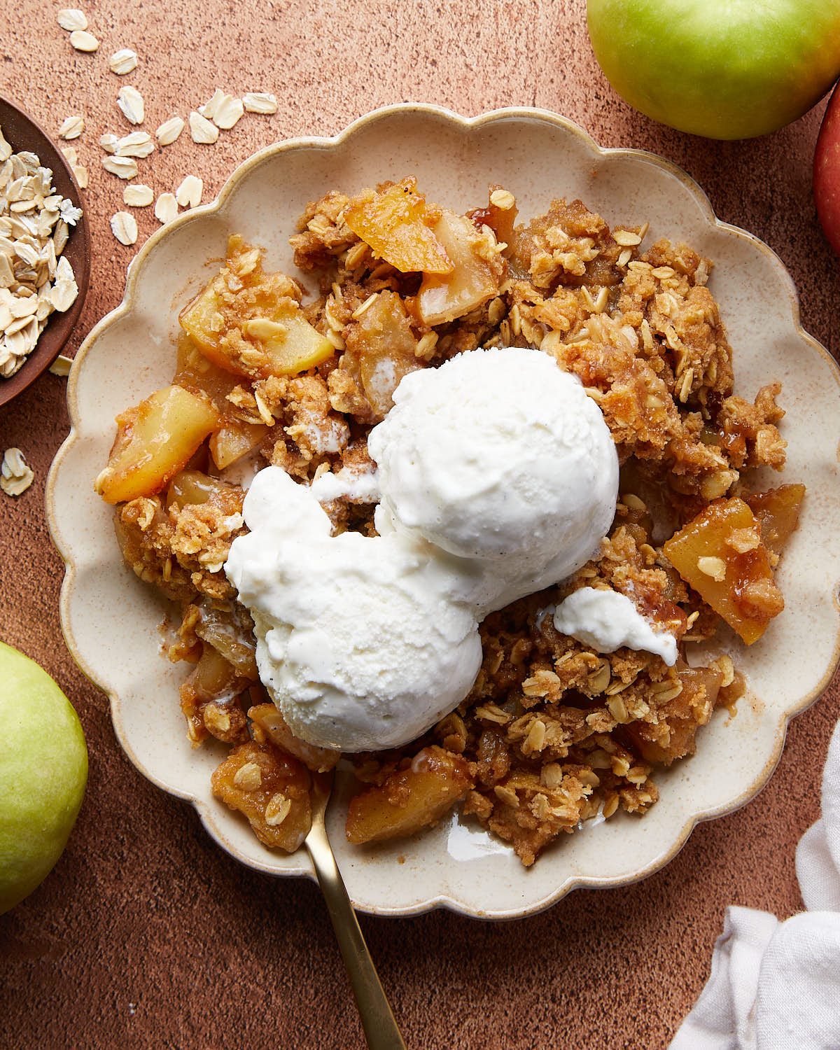 Overhead image of dutch oven apple crisp with ice cream topping.