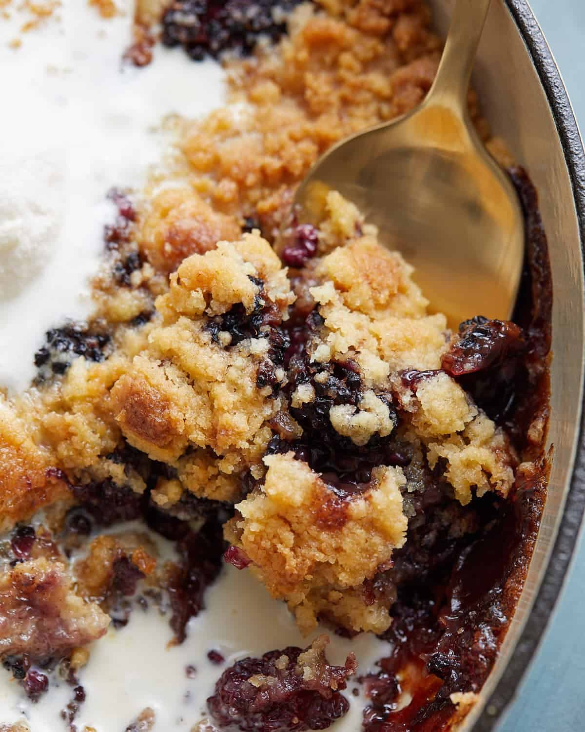 Up close image of dutch oven blackberry cobbler.