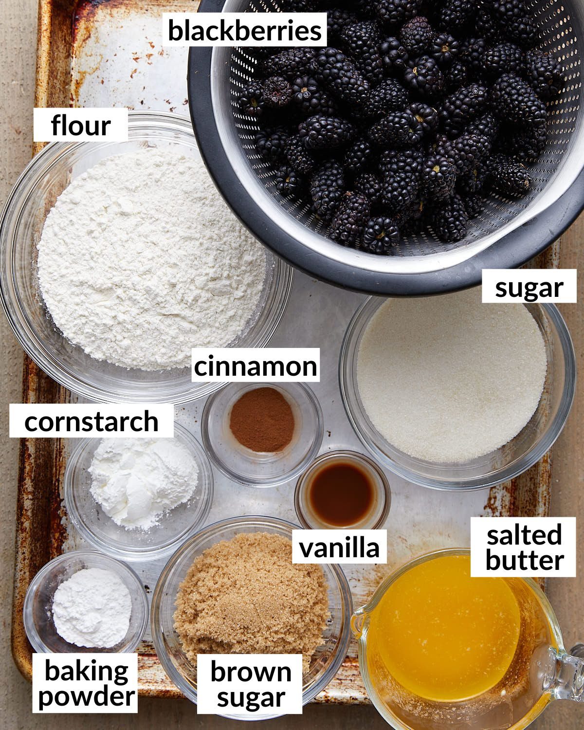 An overhead image of ingredients needed for dutch oven blackberry cobbler.
