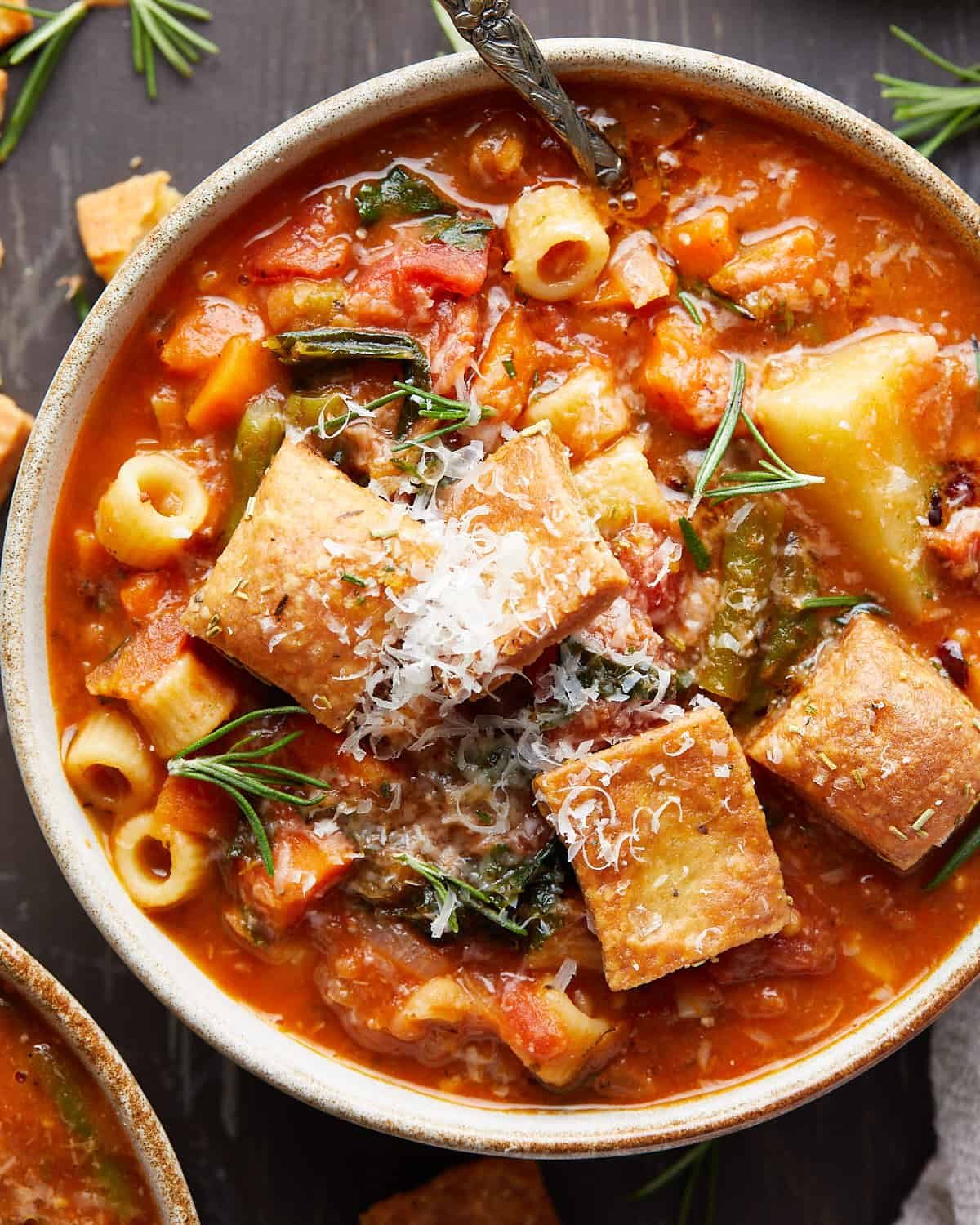 Up close image of dutch oven minestrone with garnish.