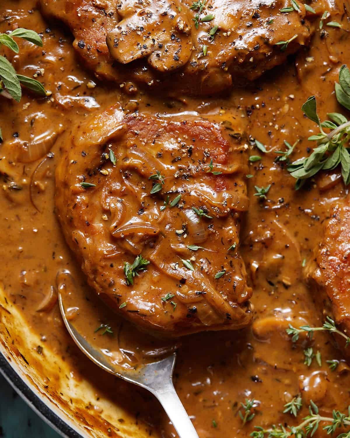 Up close overhead image of dutch oven pork chops.