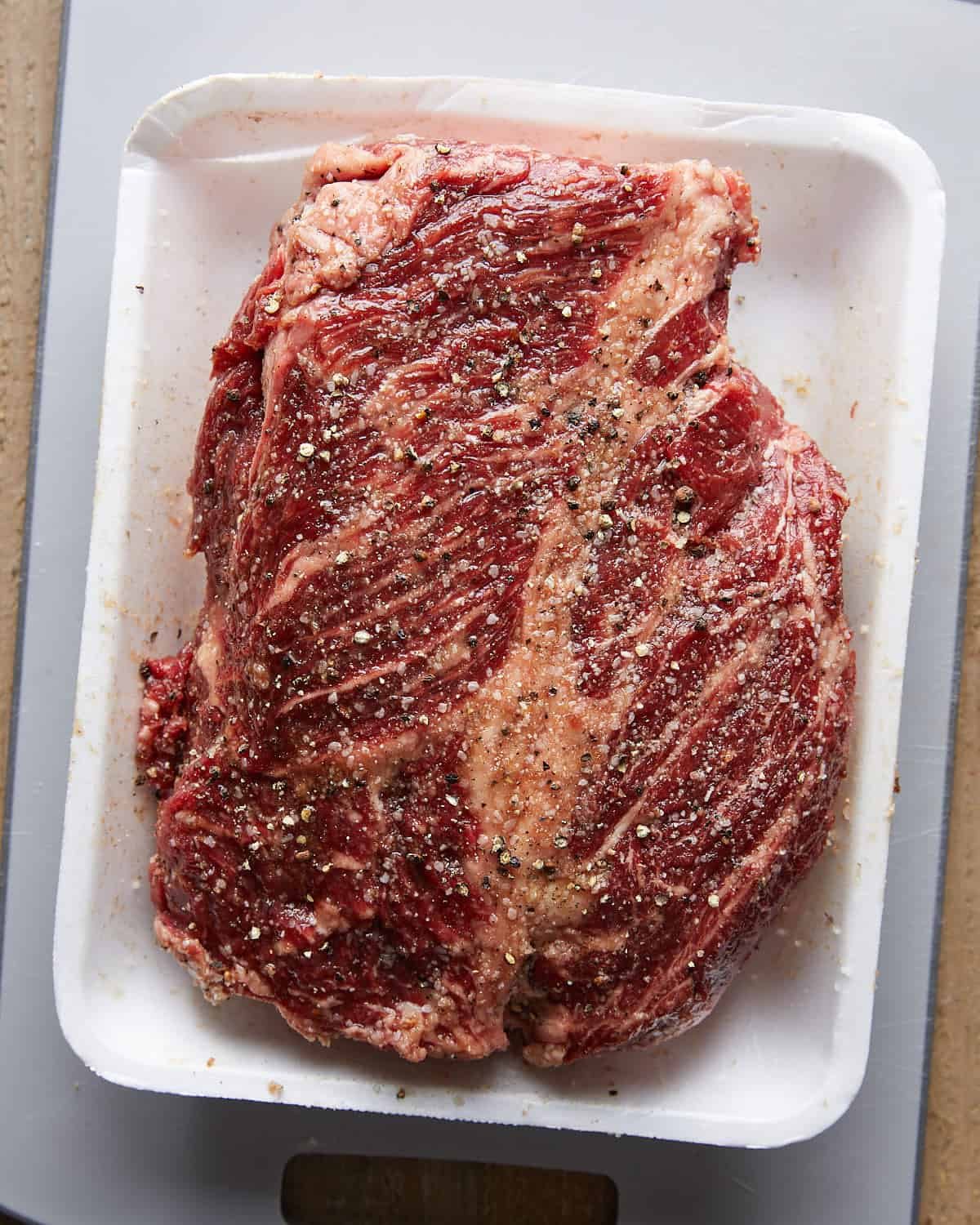 Overhead view of seasoned beef chuck roast prepared for Dutch Oven Pot Roast.