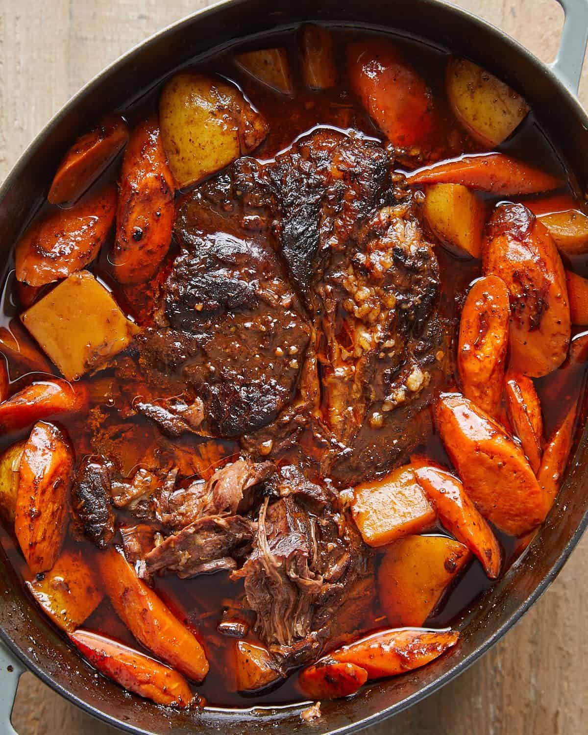 Overhead view of fully cooked Dutch Oven Pot Roast with tender beef, potatoes, and carrots.