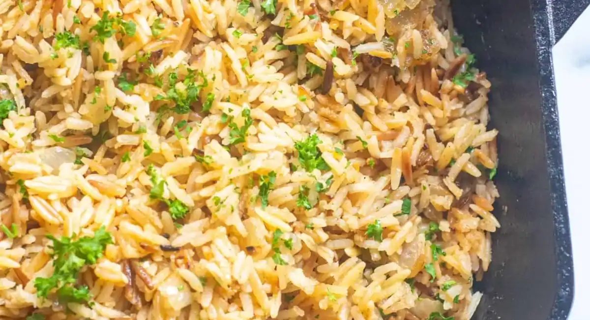 Overhead image of homemade rice pilaf with garnish.