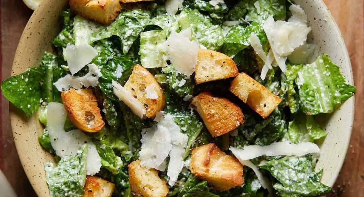 Overhead up close image of caesar salad with fresh parmesan and croutons.