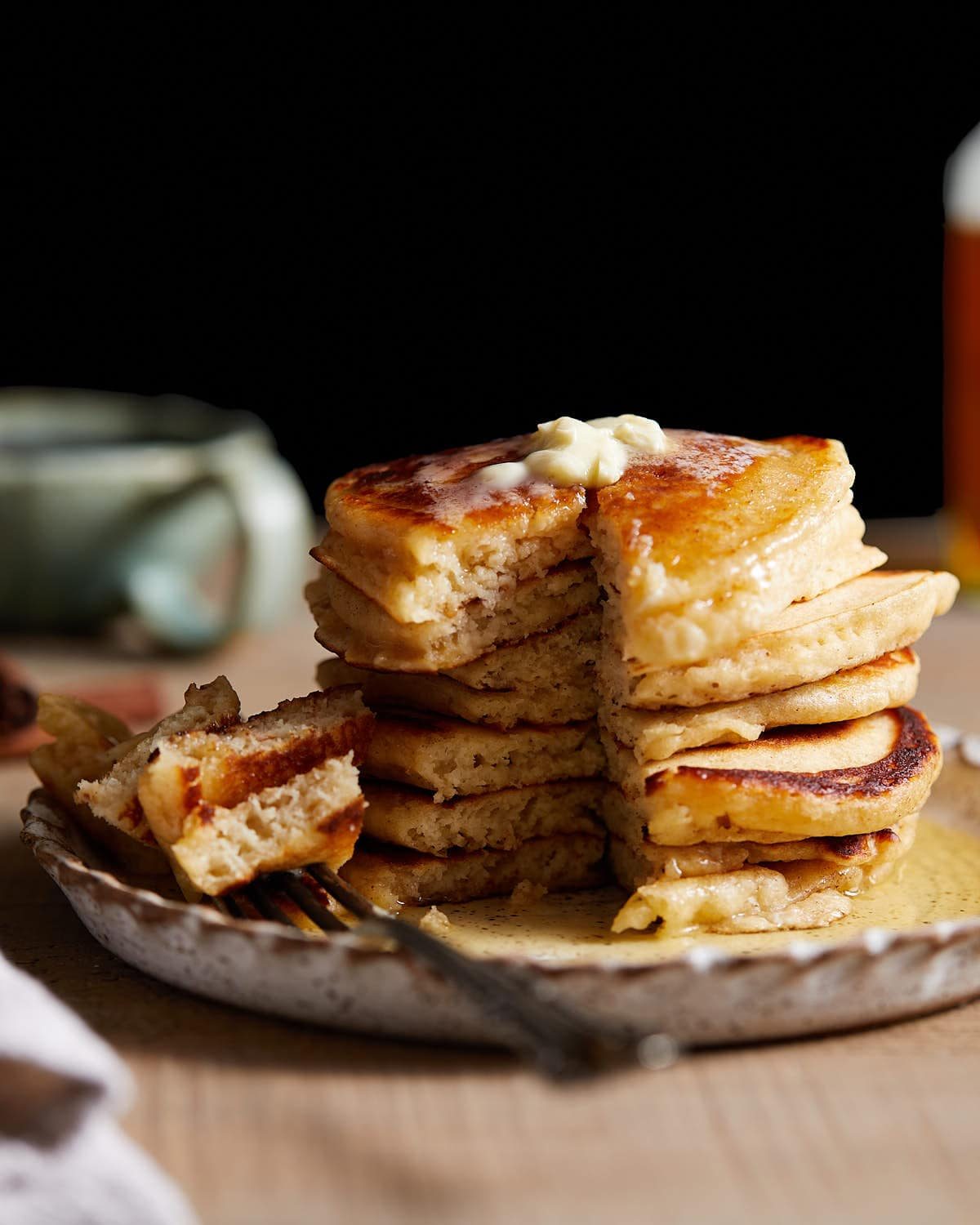 Side profile photo of a stack of buttermilk pancakes.