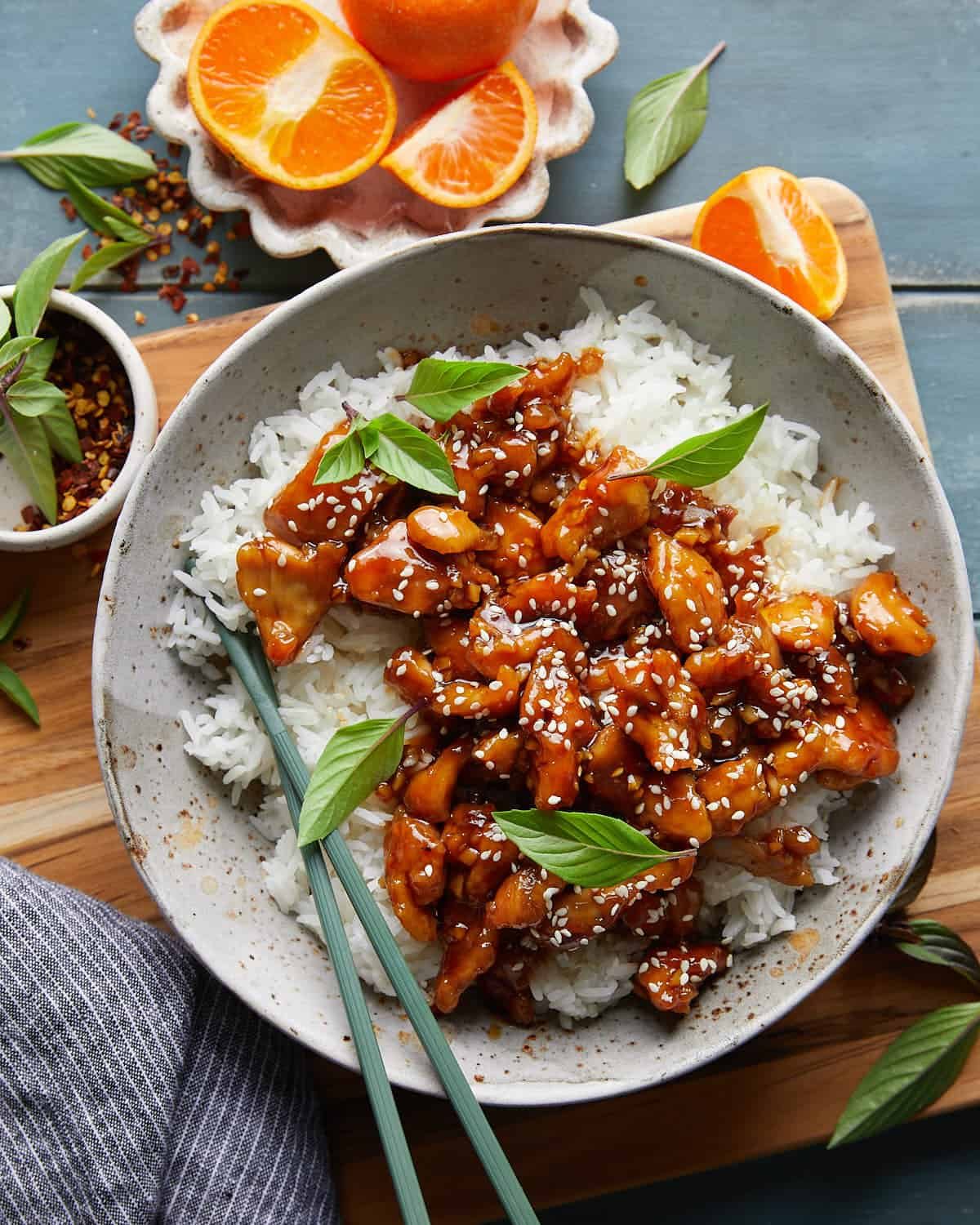 Overhead image of easy orange chicken on bed of white rice on white dish.