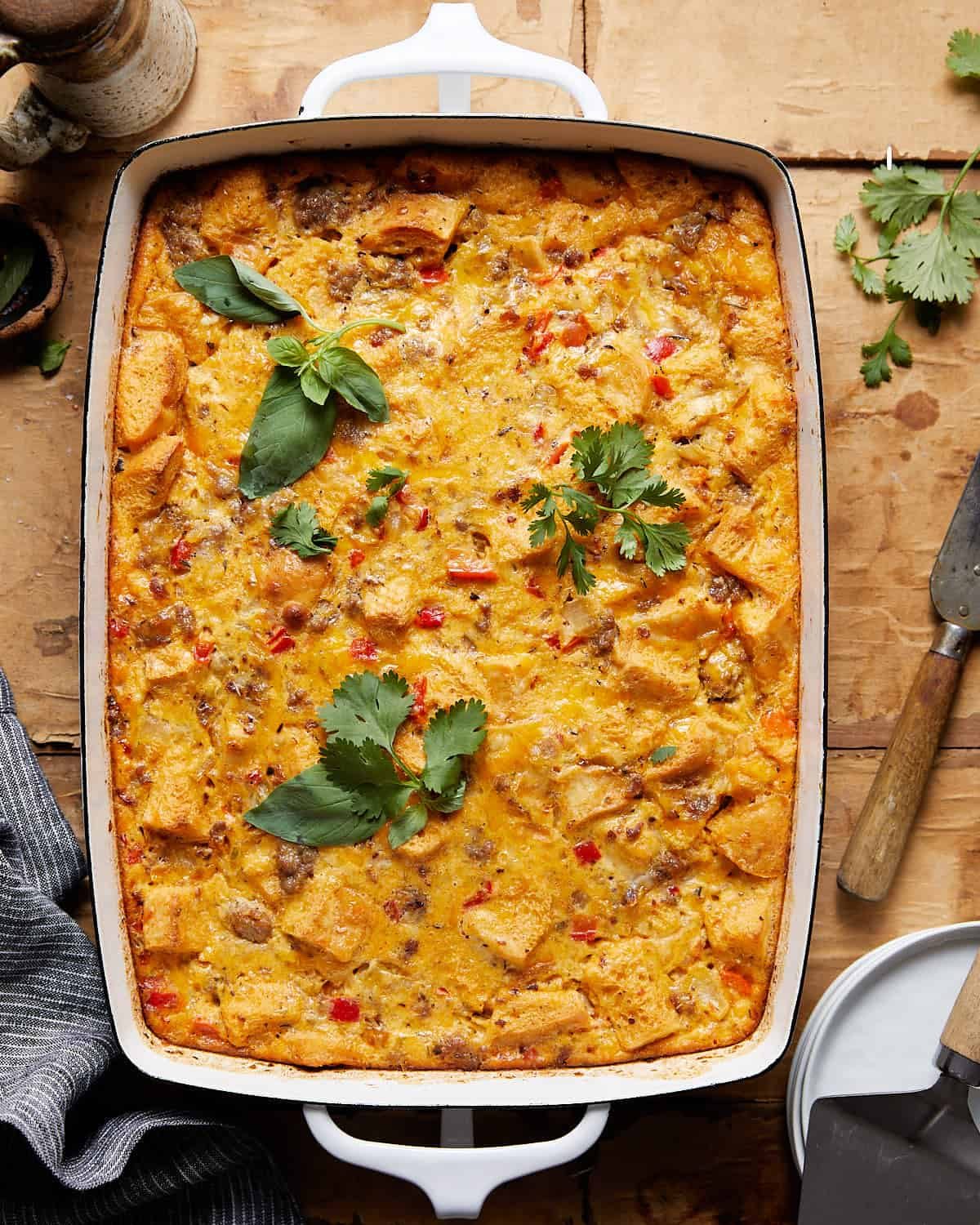 Egg sausage casserole in a white baking dish.