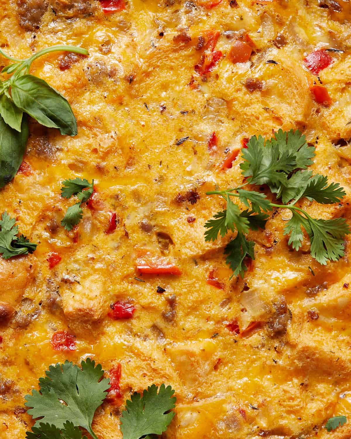 Sausage egg breakfast casserole with herbs on top.