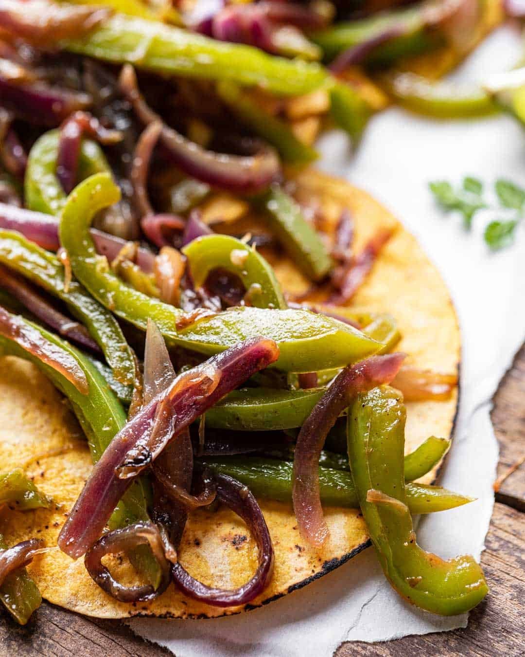 closeup of fajita veggies chipotle in a corn tortilla