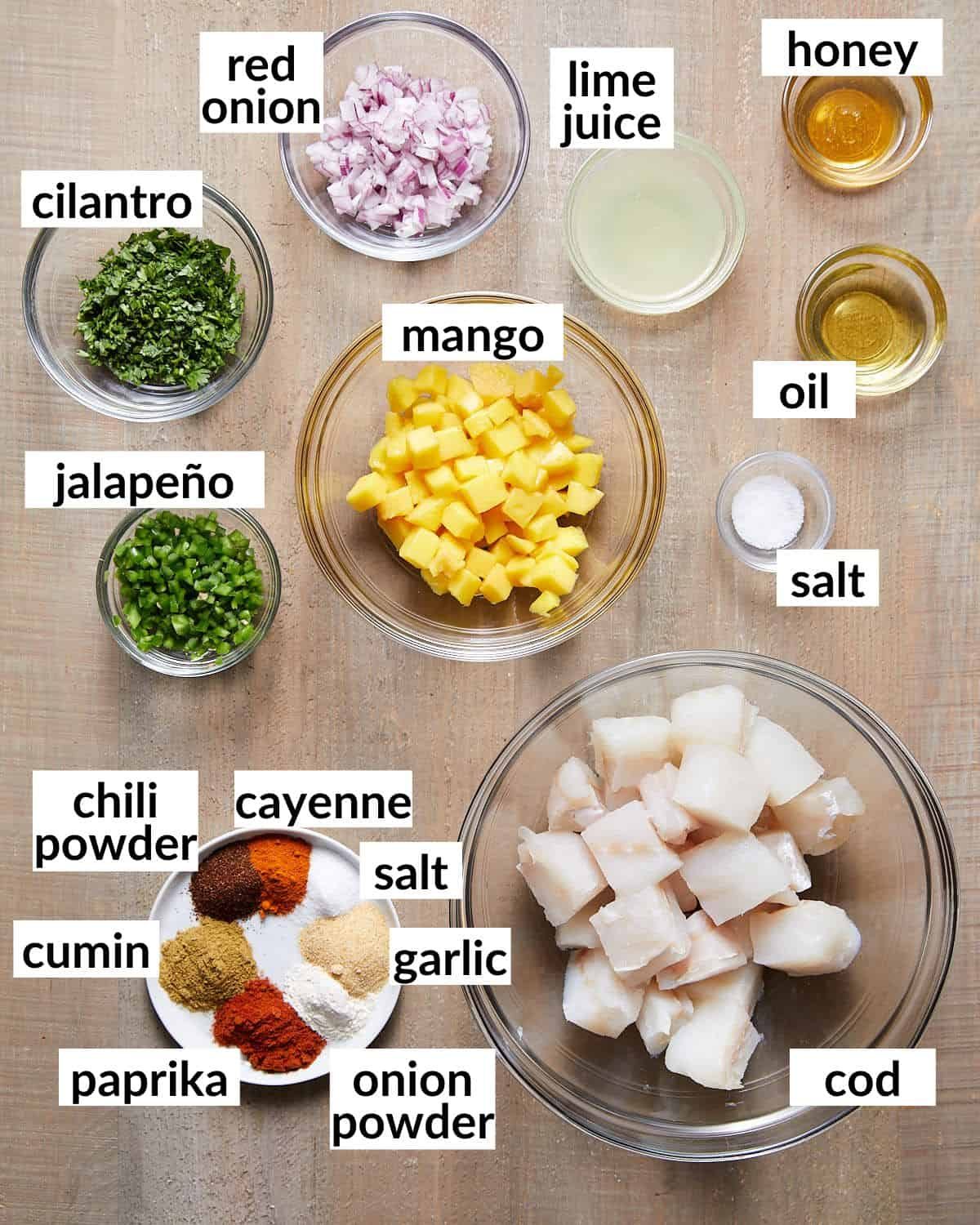 An overhead image of ingredients needed for fish tacos and mango salsa.
