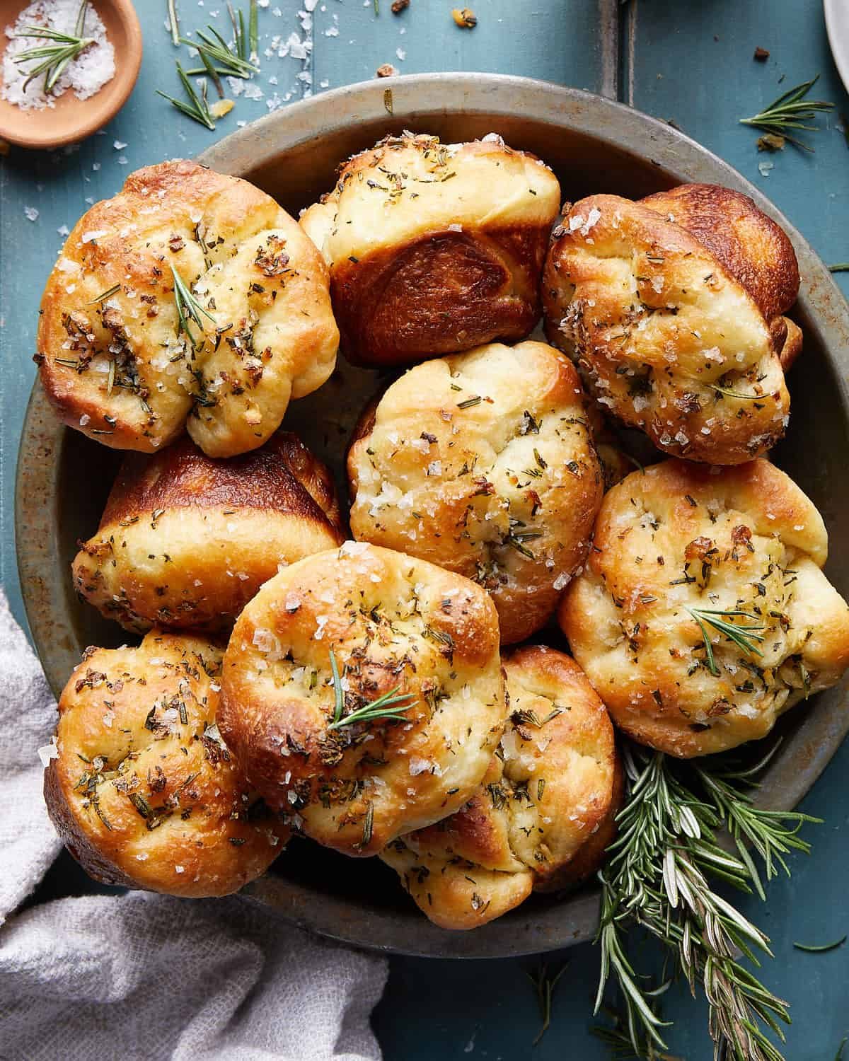 Overhead image of facaccia muffins with garnish.