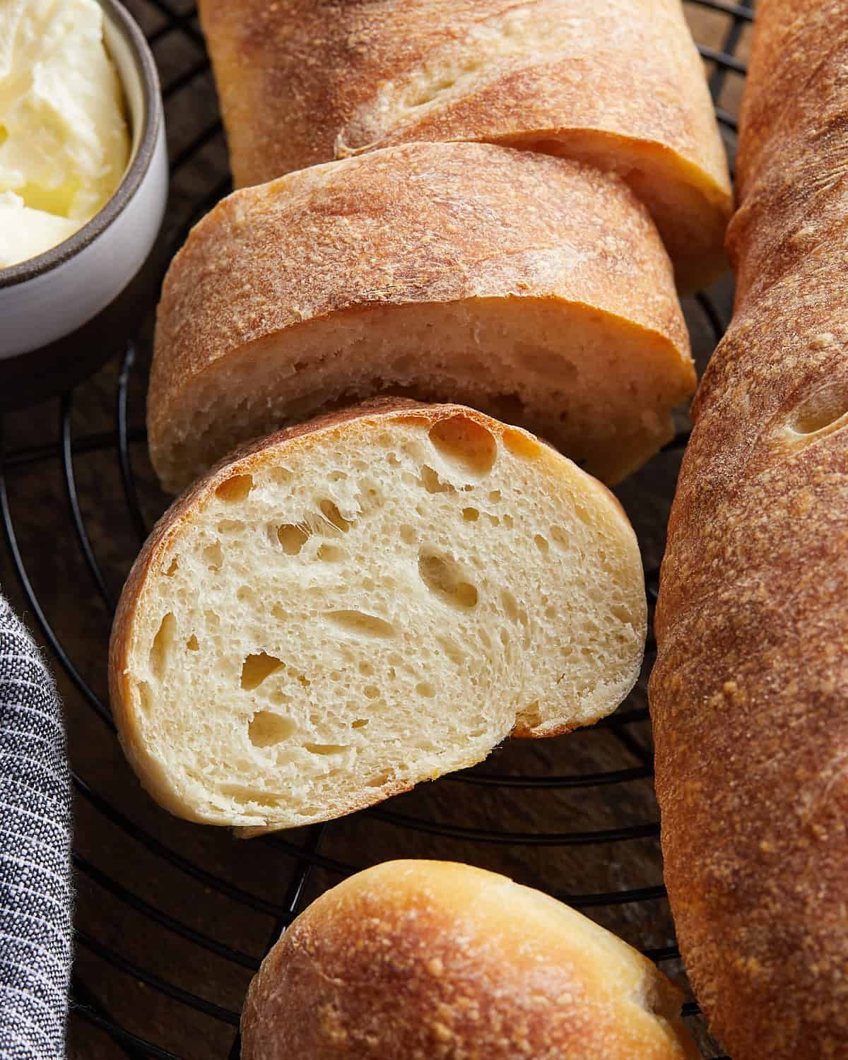 Up close overhead image of cut french bread on wire rack.