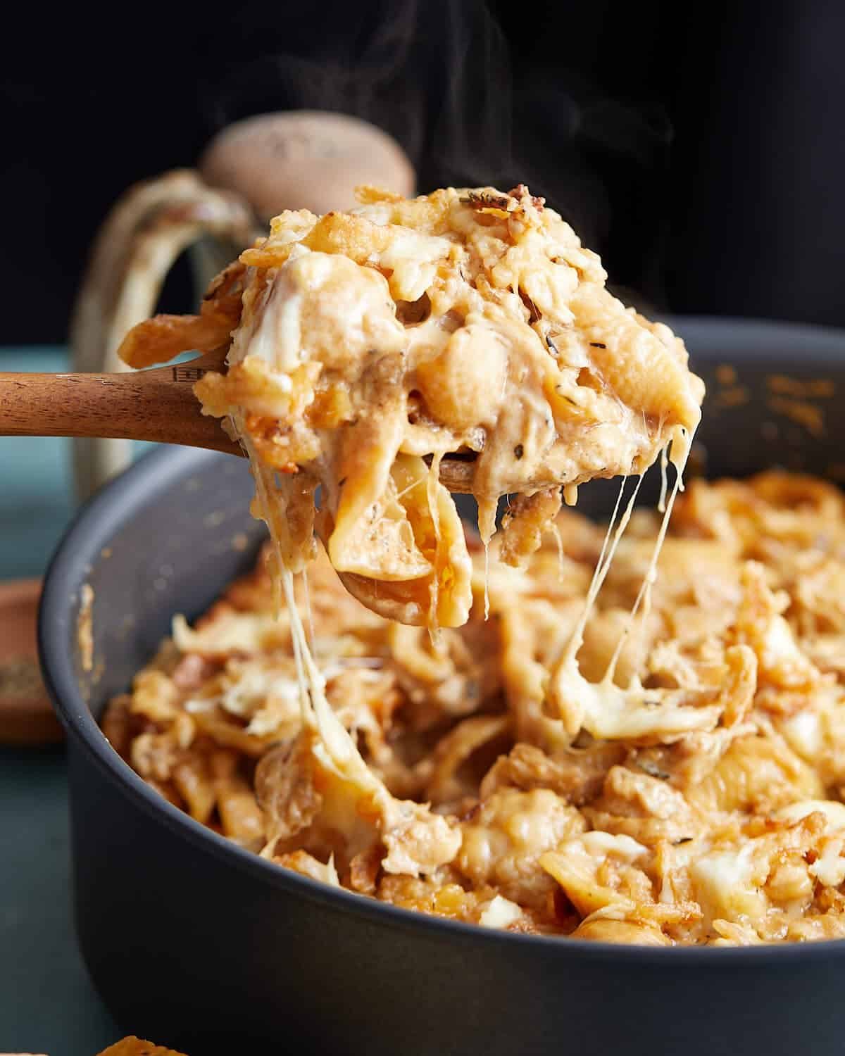 Up close image of french onion mac and cheese in black skillet.
