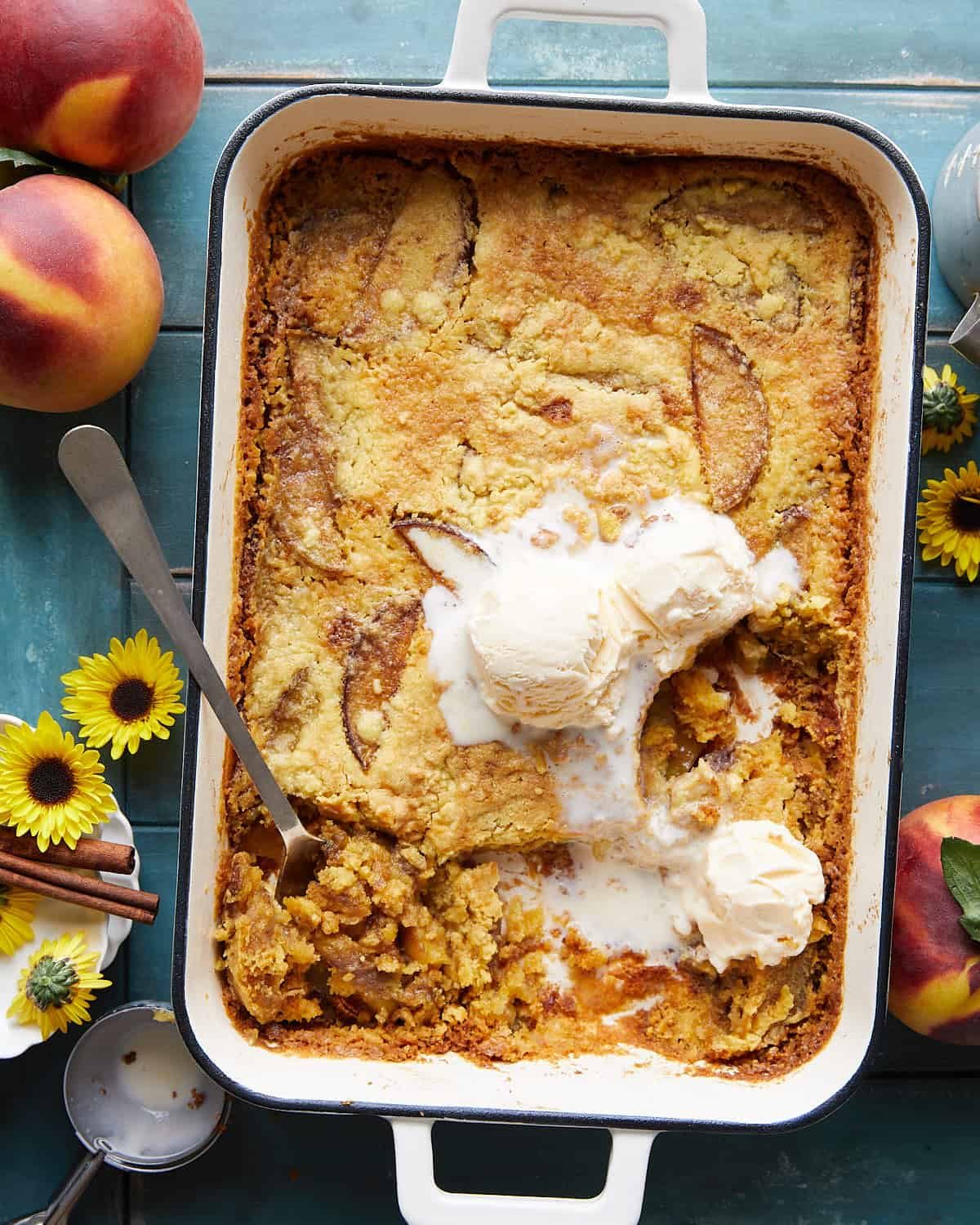 Overhead image of peach dump cake with ice cream topping.