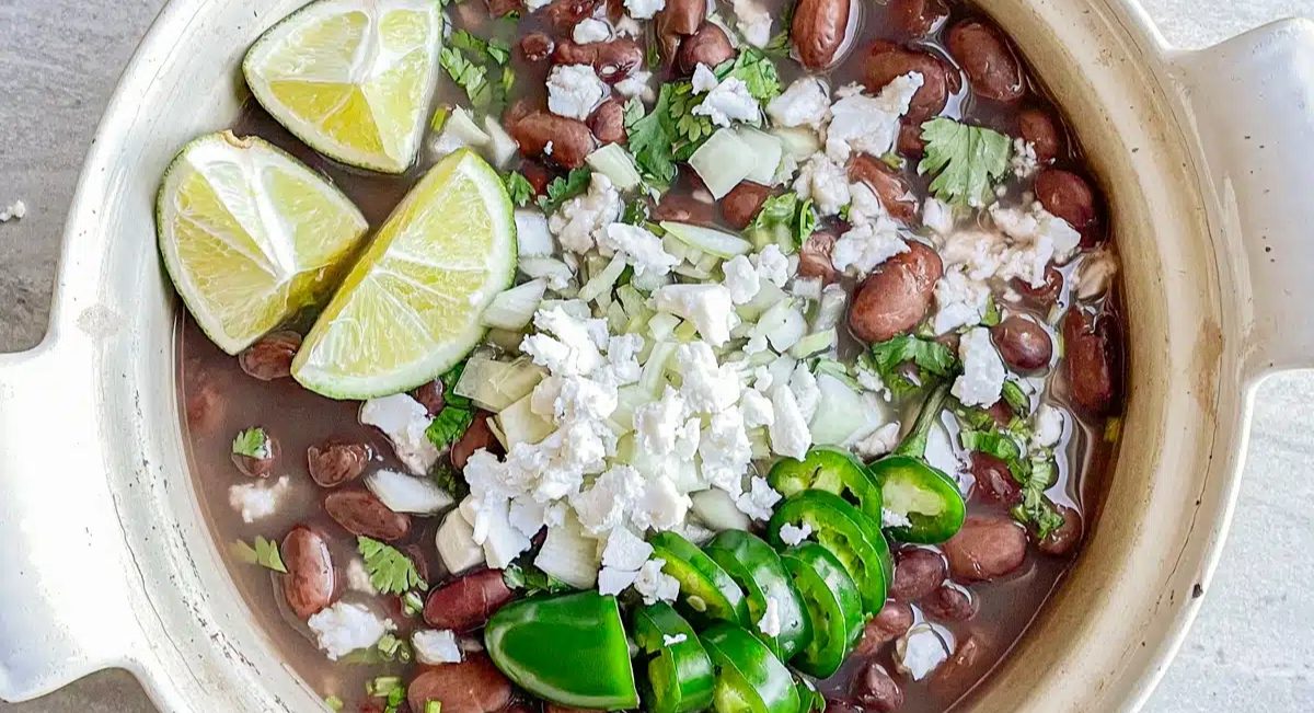 Overhead image of frijoles de la olla with garnish.