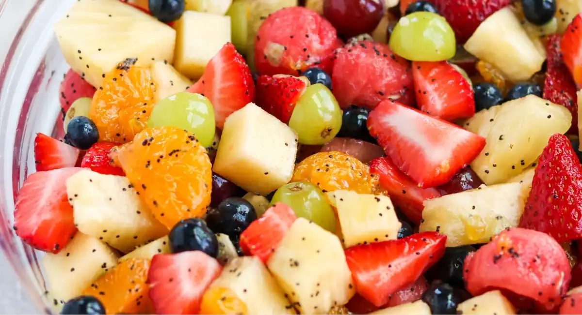Overhead up close image of honey lime poppyseed fruit salad.