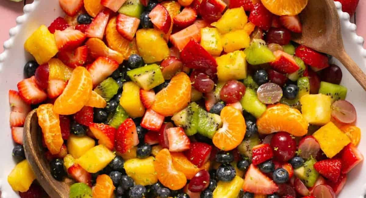 Overhead image of rainbow fruit salad with honey lime dressing.