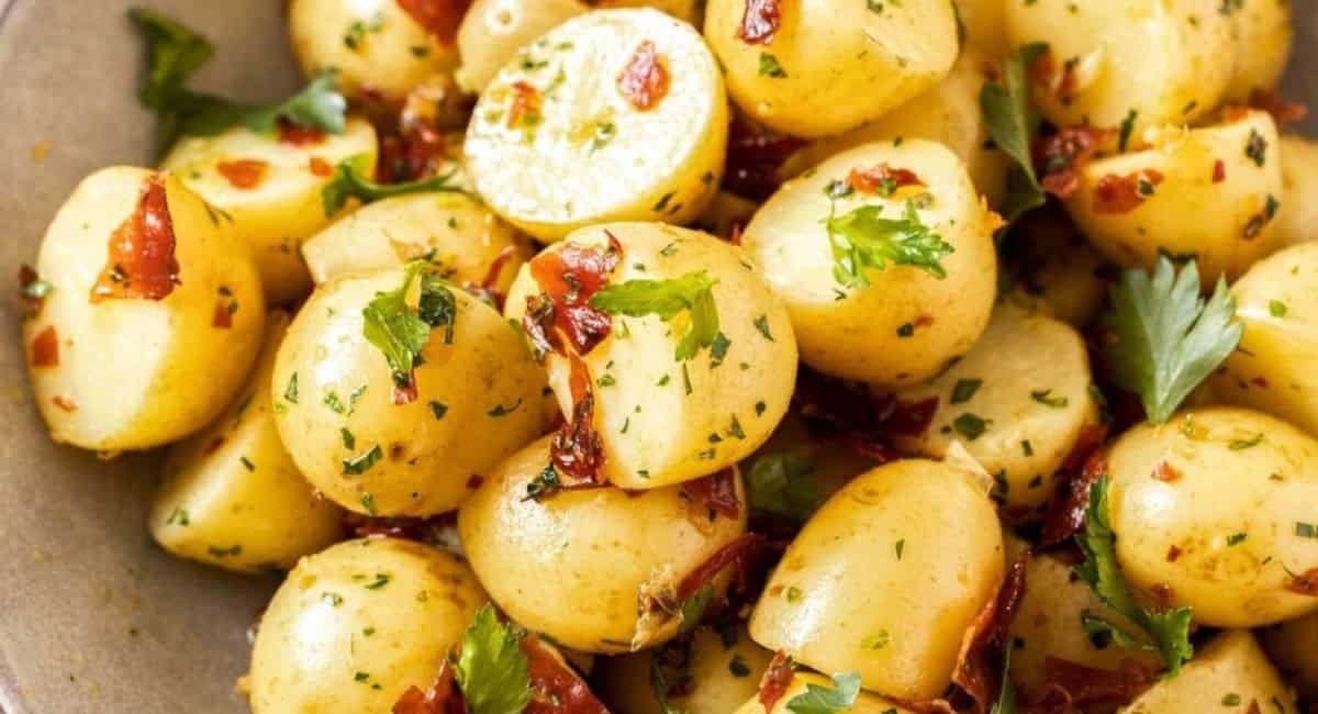 Overhead image of garlic butter potatoes with crispy prosciutto.