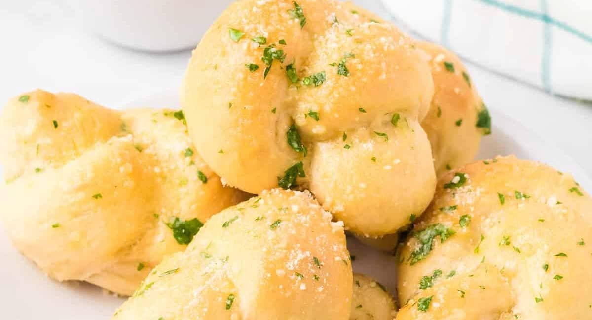 Up close image of garlic knots with garnish.