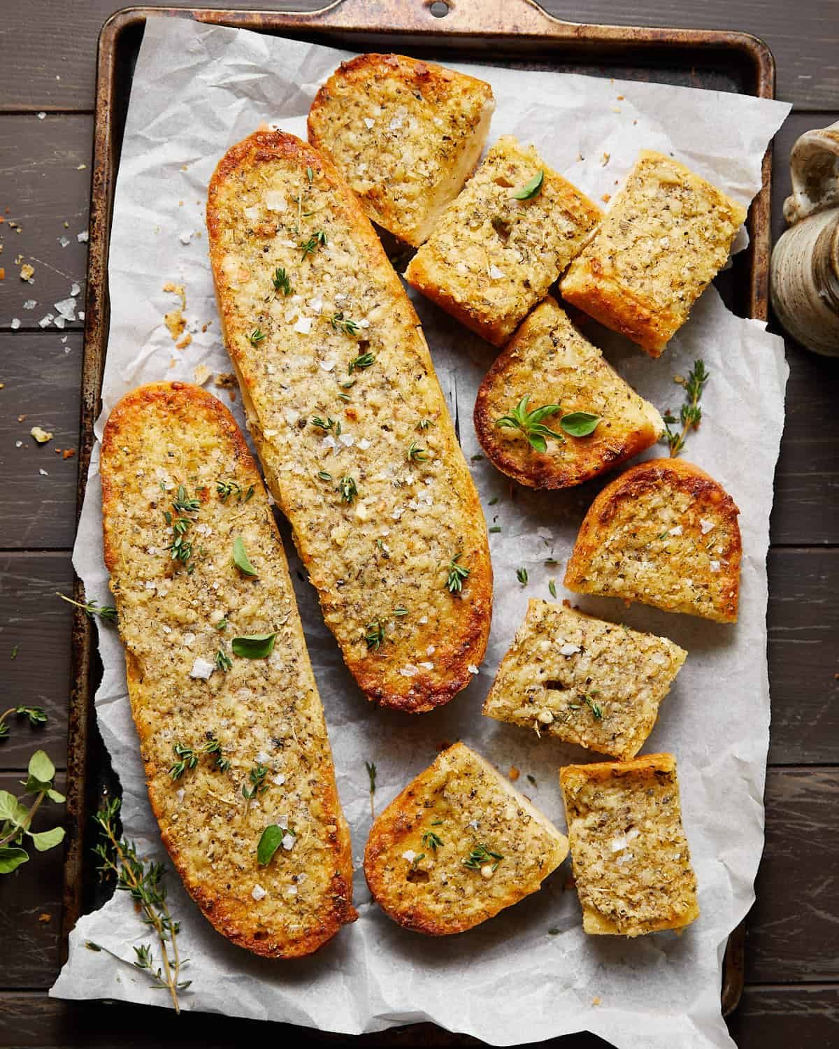 Image of garlic bread spread with garnish.