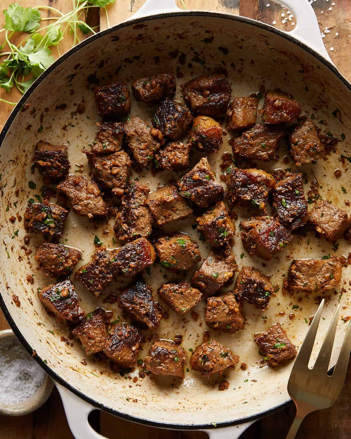 Overhead image of garlic butter steak bites with garnish.