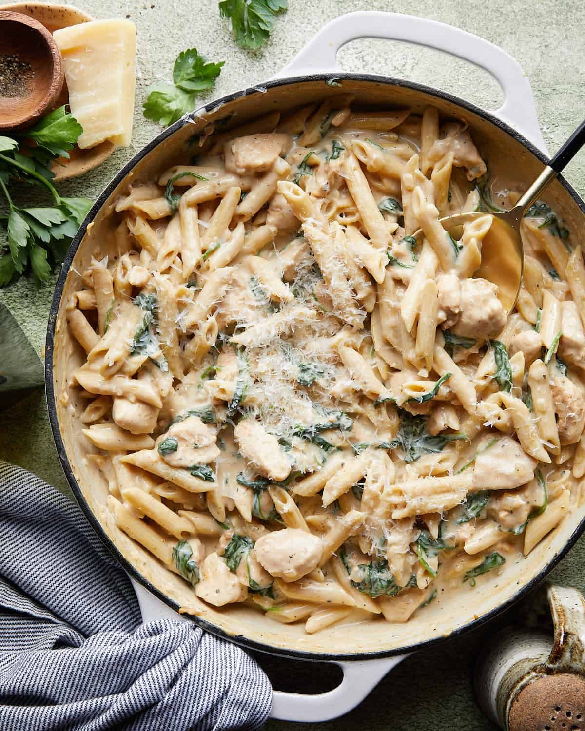 Overhead image of garlic chicken pasta with garnish.