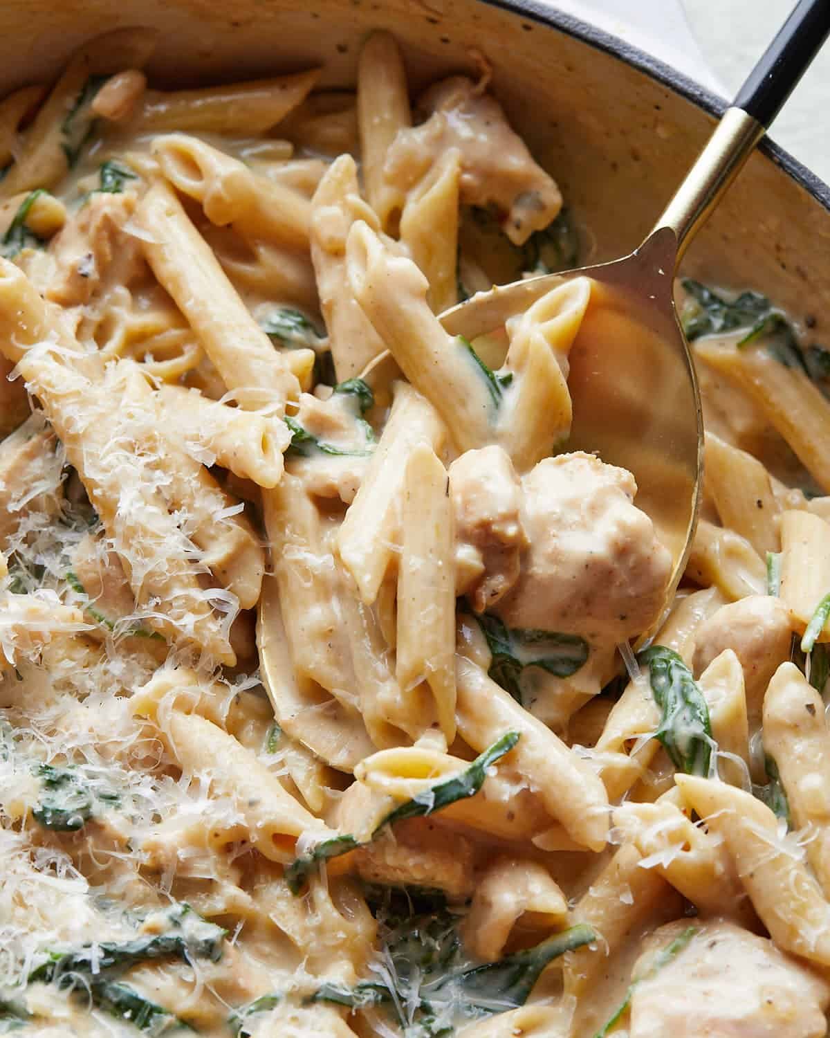 Up close image of garlic chicken pasta with garnish.