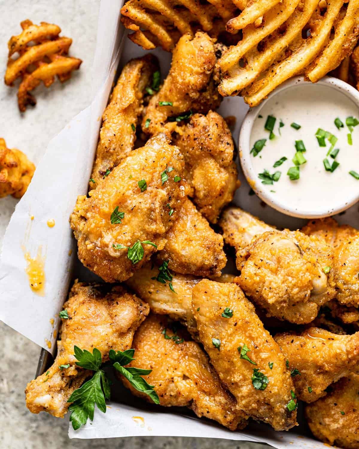 Up close image of air fryer garlic parmesan with garnish.