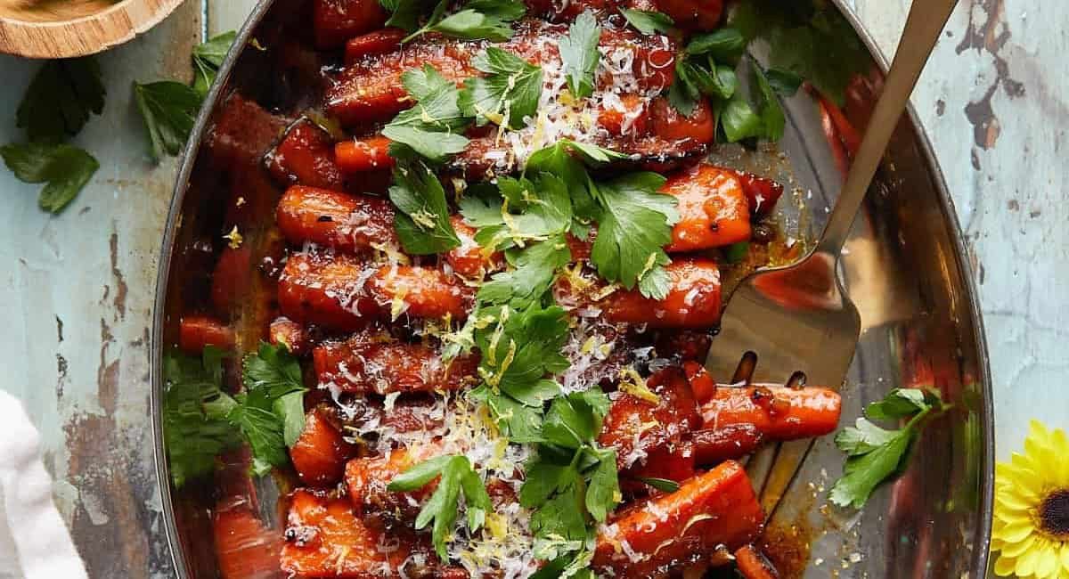 Overhead image of glazed stovetop carrots with garnish.