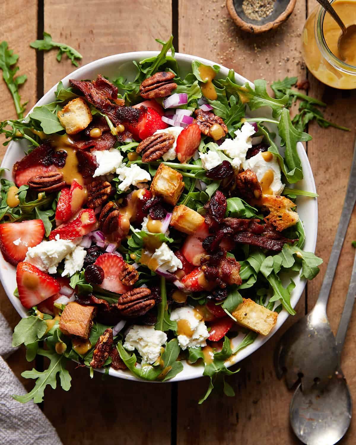 Goat cheese salad in white bowl.
