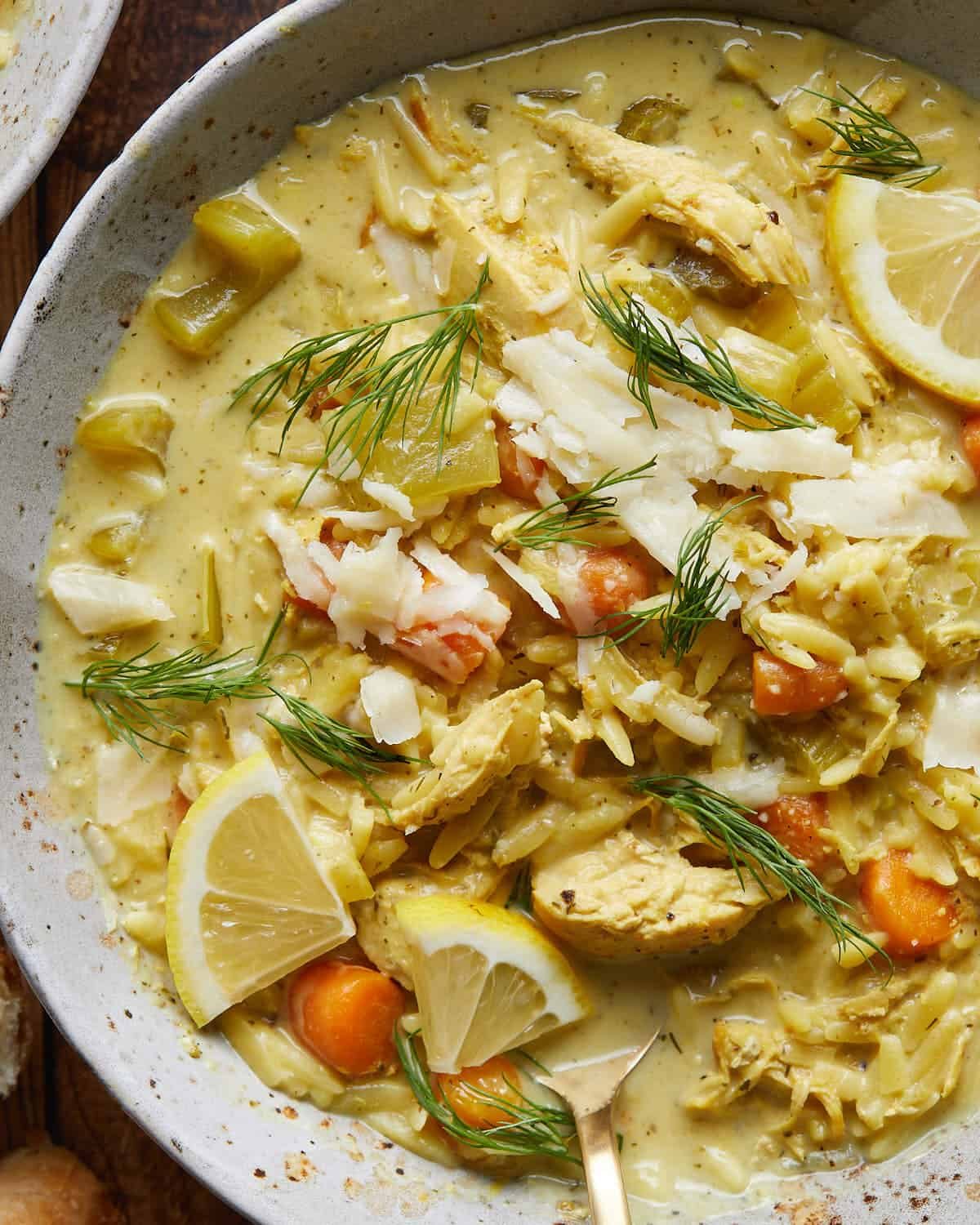 Up close image of Greek lemon chicken soup with orzo.