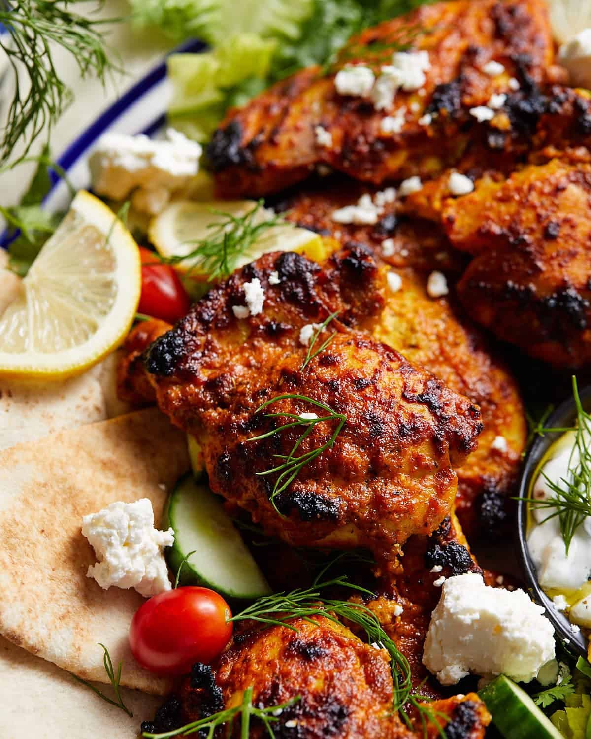 Greek yogurt chicken thigh with fresh dill on top.