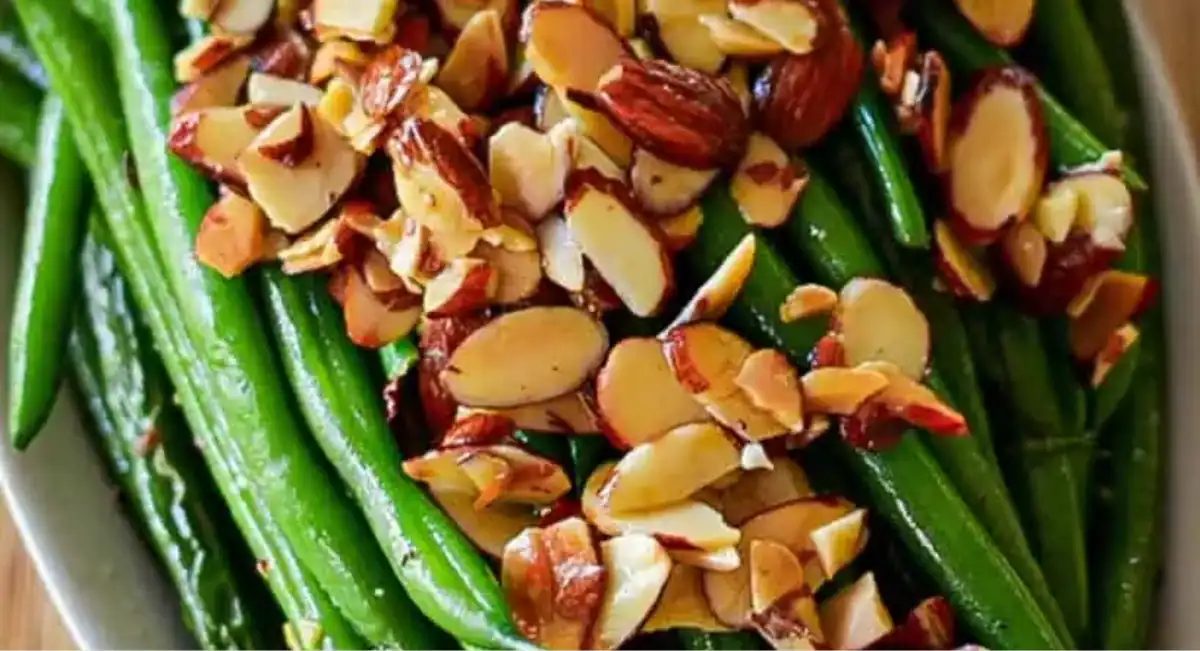Overhead up close image of green beans with toasted almonds and garlic.