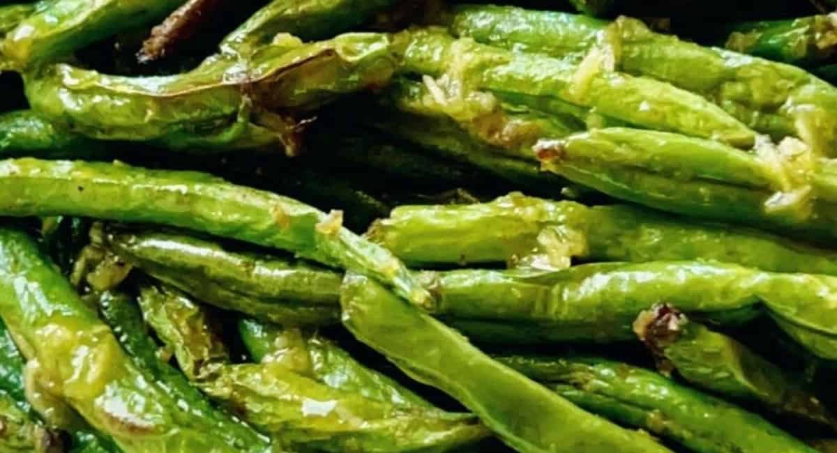 Up close image of air fryer green beans with garlic butter sauce.