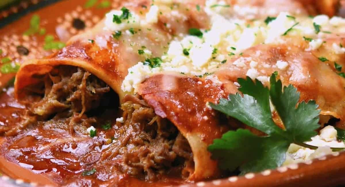 Up close image of shredded beef green chiles enchiladas.