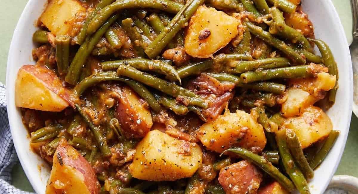 Overhead image of green beans and potatoes recipe in white bowl.