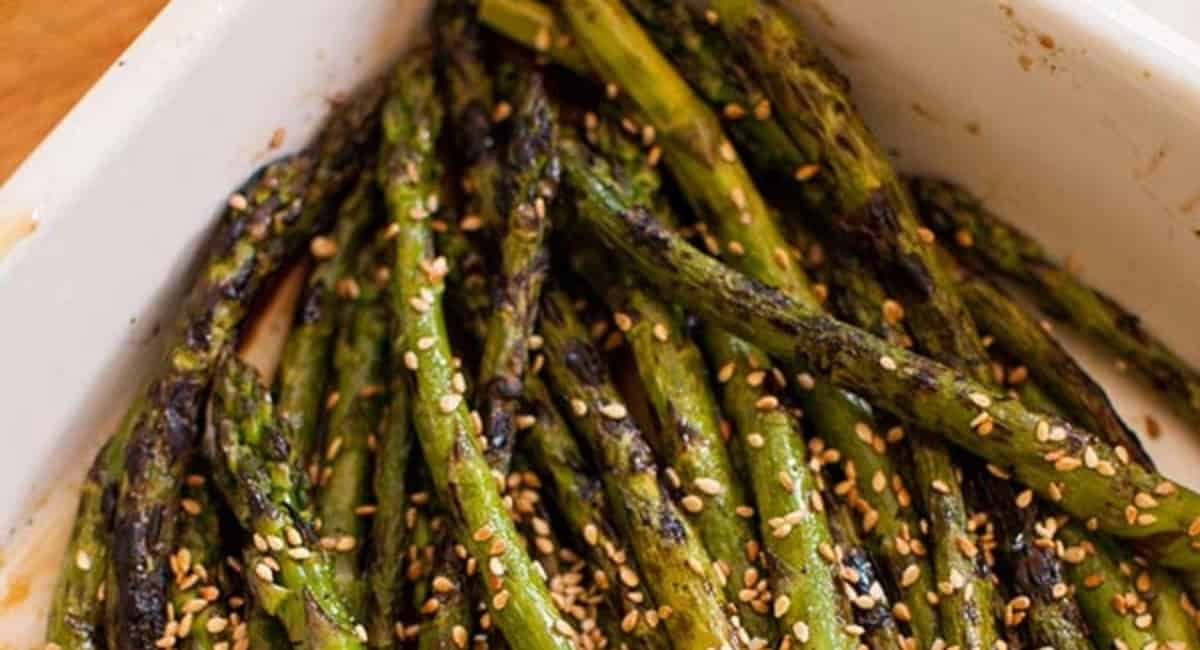 Overhead image of grilled asparagus with sesame dressing.