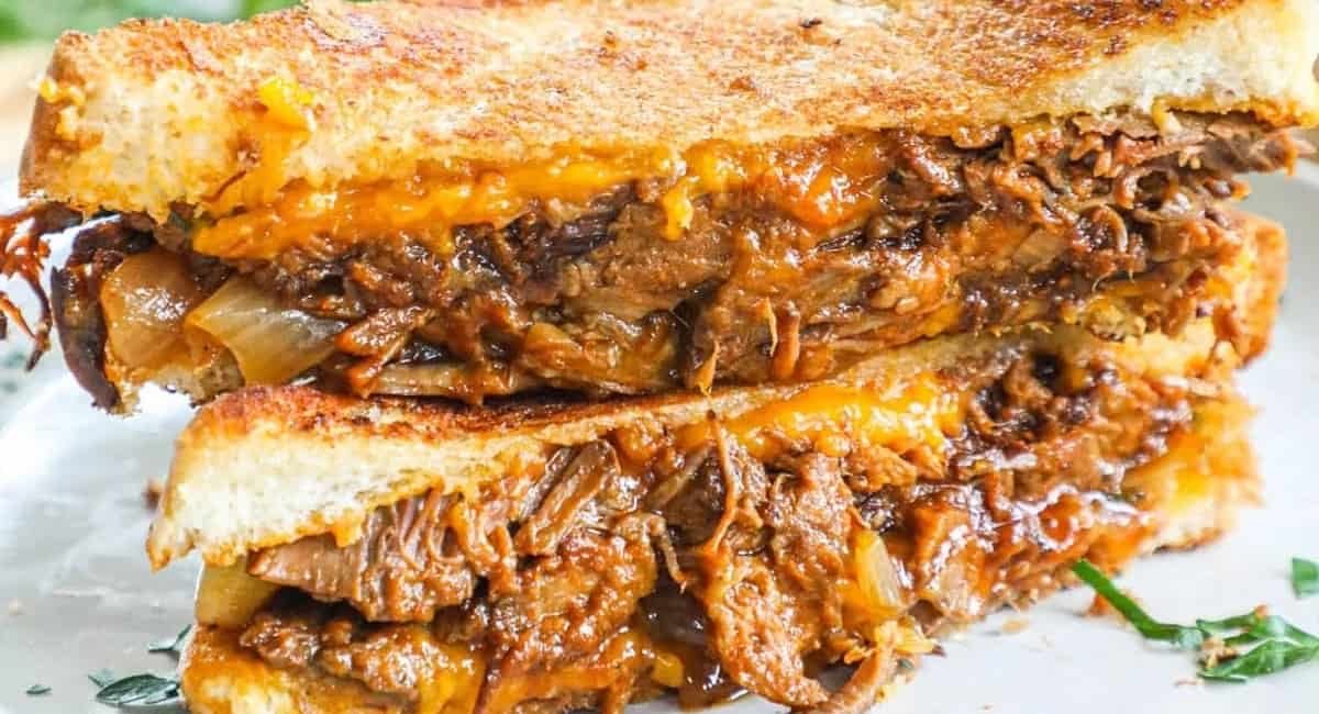 Up close image of grilled cheese brisket sandwich.