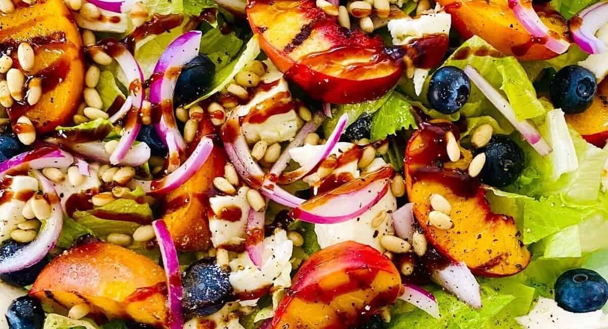 Up close image of grilled peach salad with fresh mozzarella.