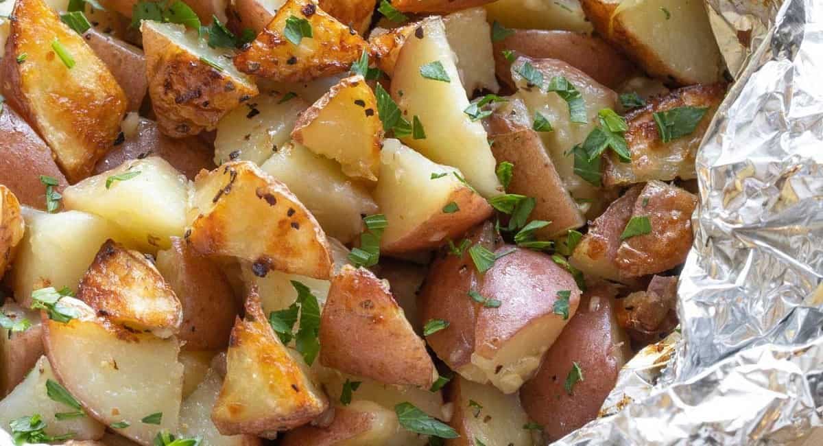 Overhead image of grilled potatoes in foil.