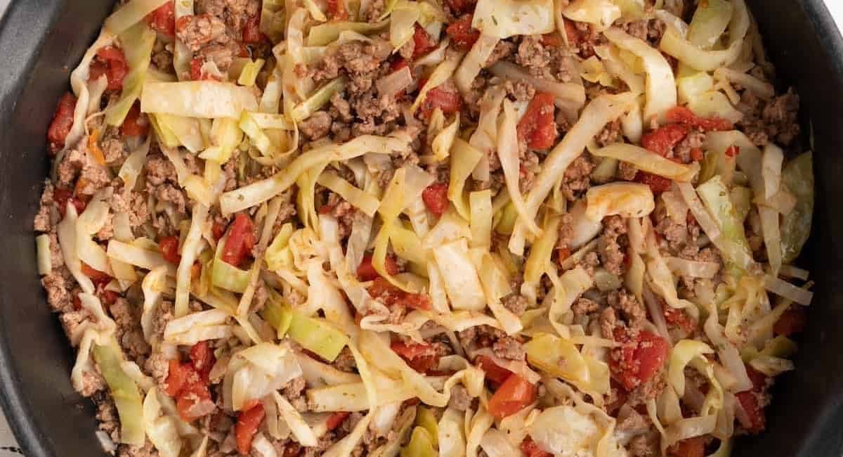Overhead image of ground beef and cabbage.