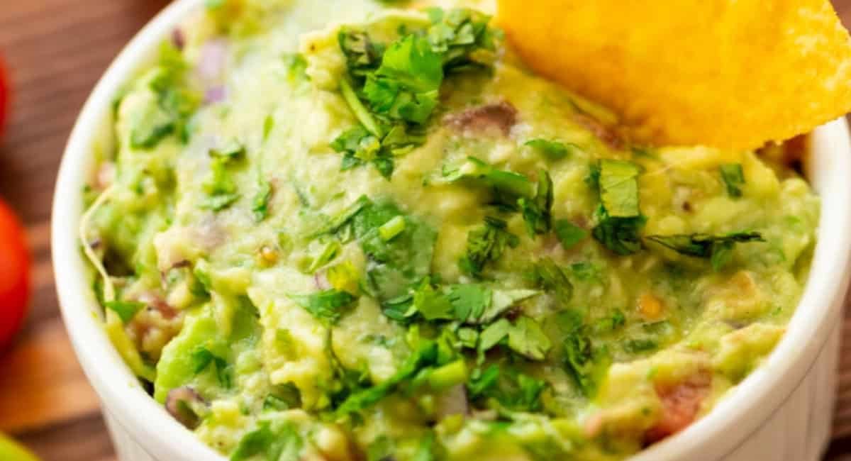 Up close image of tableside guacamole with garnish.