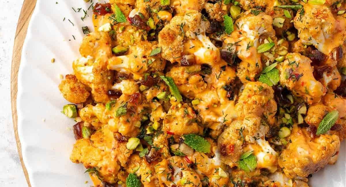 Overhead image of harissa tahini cauliflower with garnish.