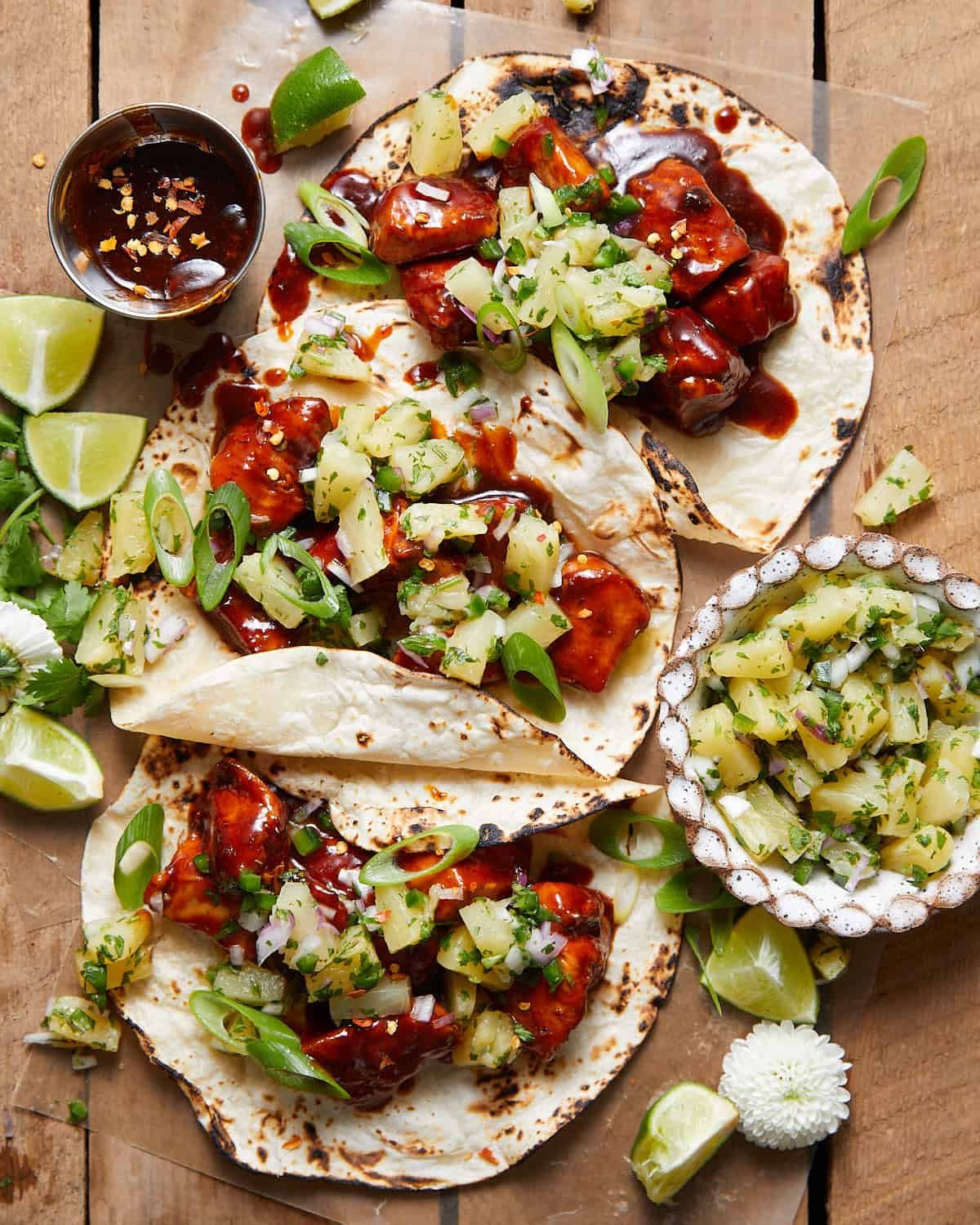 Overhead image of Hawaiian chicken tacos with garnish.