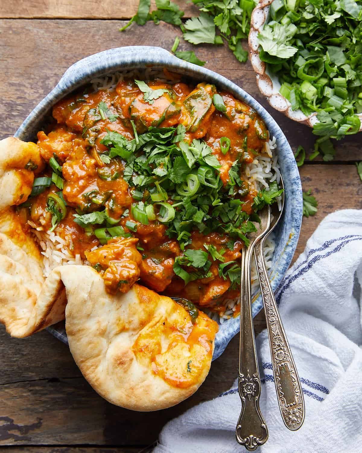 Overhead image of healthy chicken curry with garnish.