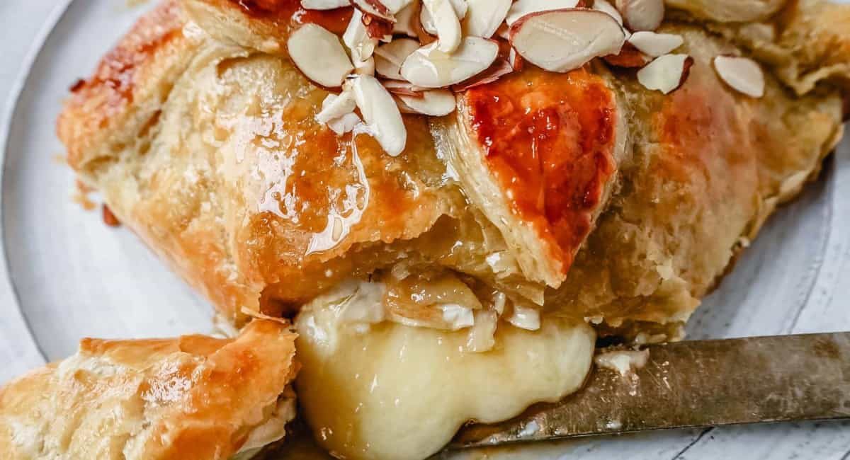 Up close image of honey almond puff pastry wrapped brie.