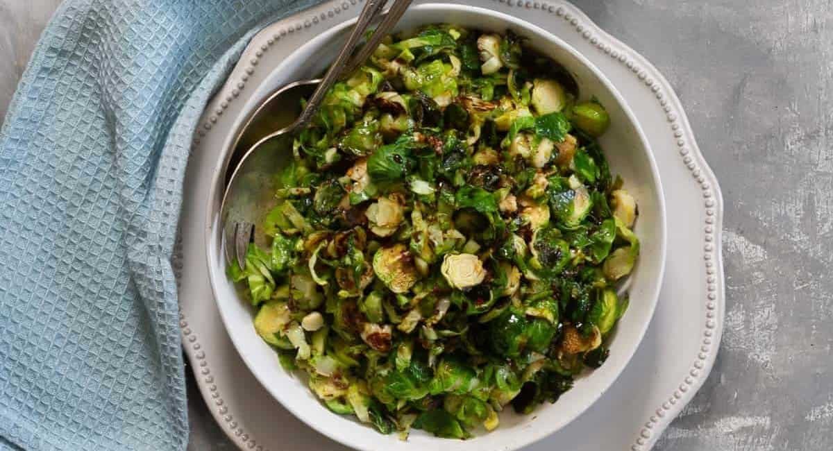 Overhead image of honey balsamic brussels sprouts in white bowl.
