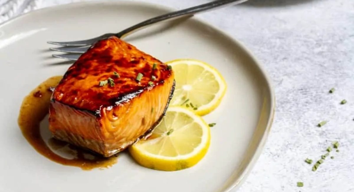 Up close image of honey bourbon salmon with garnish.